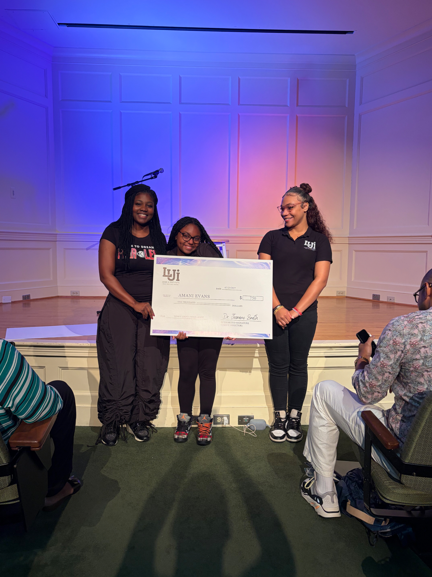 Dr. Jasmine Smith presenting a Lead U Legacy Scholarship check to students